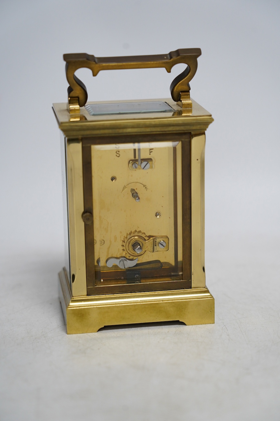 A carriage timepiece with white enamelled Roman dial, in a gilt brass and glazed case, 13cm. Condition - fair to good, not tested as working